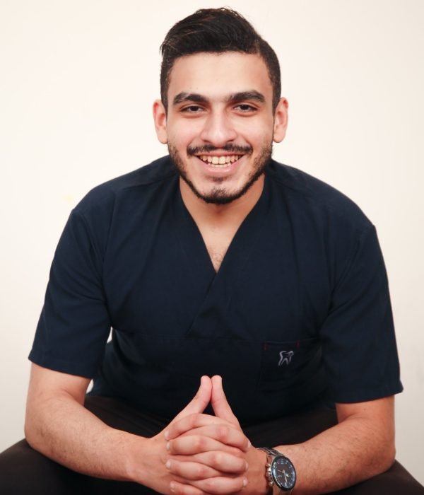 Dr. Mohamed Sharshera, a skilled dentist, smiling confidently at his dental center in Dubai, ready to offer expert care.
